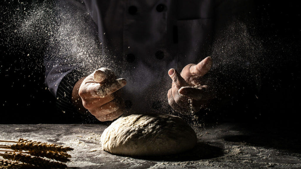 Bakers at work with dough - traditional rye bread production
