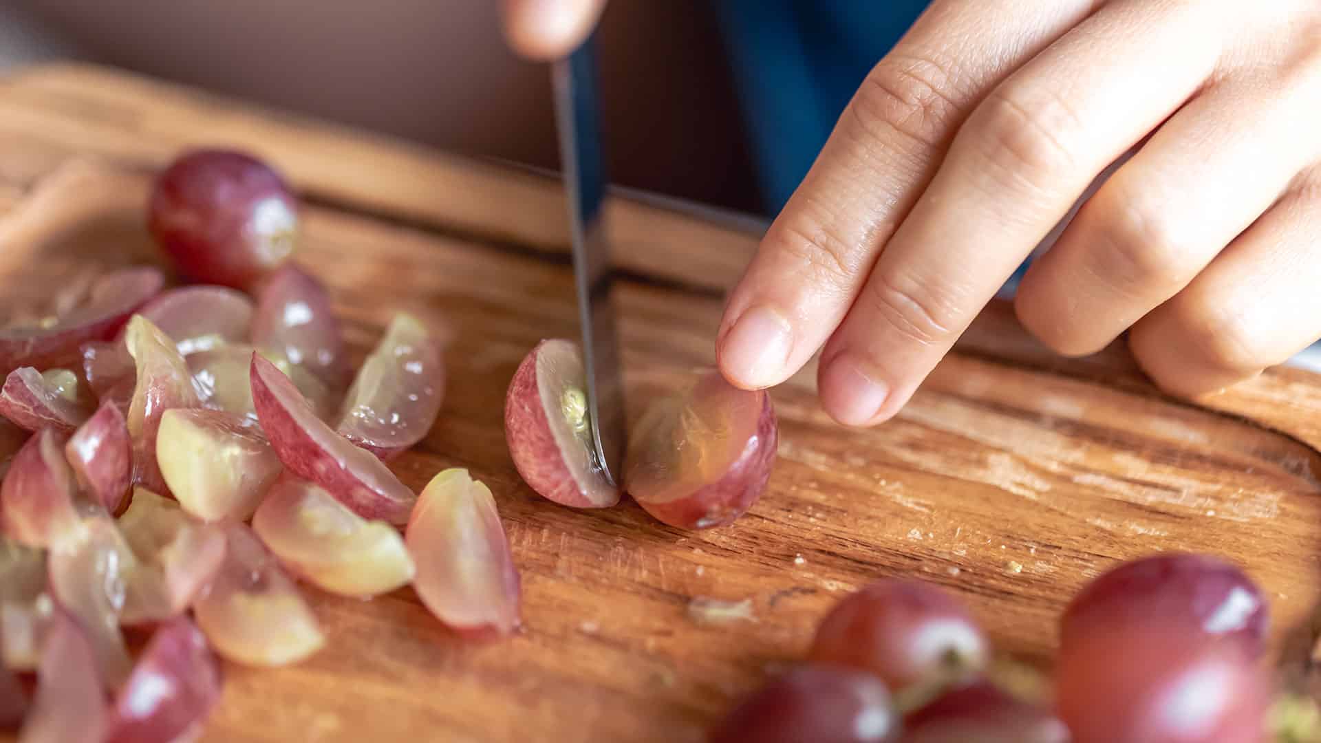 in vino frau schneidet weintrauben