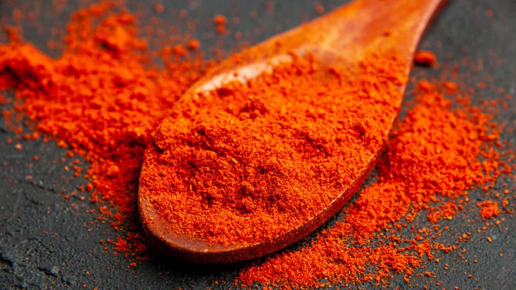 Saffron powder on a wooden spoon - aromatic spice from Valais