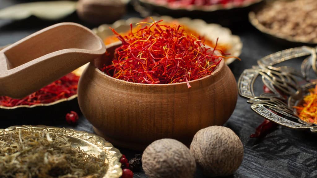 Saffron still life - decorative arrangement of threads, flowers and bulbs